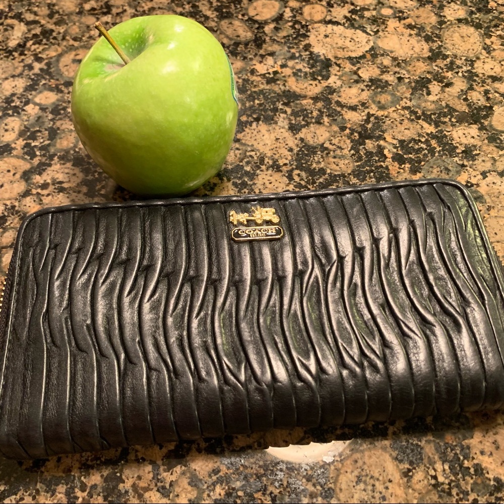 Coach Leather Madison accordion wallet in black.